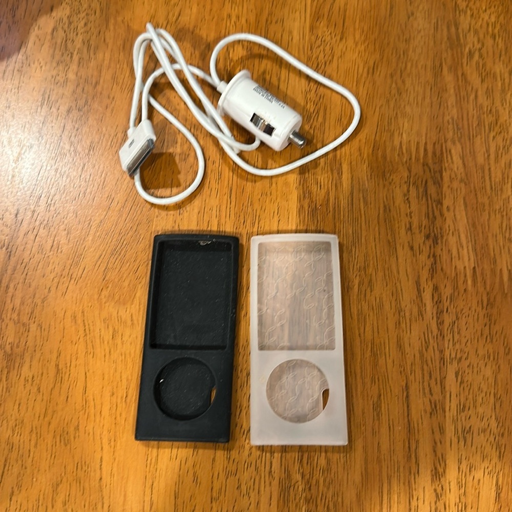 Apple iPod covers and charger. Black and clear covers. Charger is white. EUC